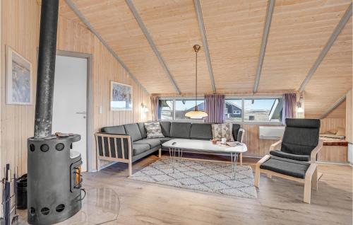 a living room with a couch and a stove at Holiday Home Klægdalen Ringkøbing Xii in Søndervig