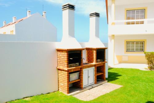 a brick oven in the side of a house at Catarina House - Baleal Beach, Balcony, Pool in Ferrel