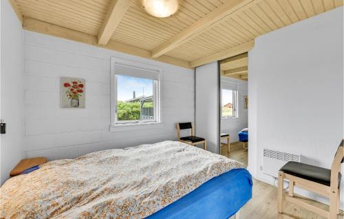 ein Schlafzimmer mit einem großen Bett und einem Fenster in der Unterkunft 4 Bedroom Lovely Home In Ringkbing in Søndervig