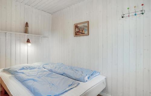 a white room with a bed with blue sheets at Stunning Home In Blvand With 3 Bedrooms And Wifi in Blåvand