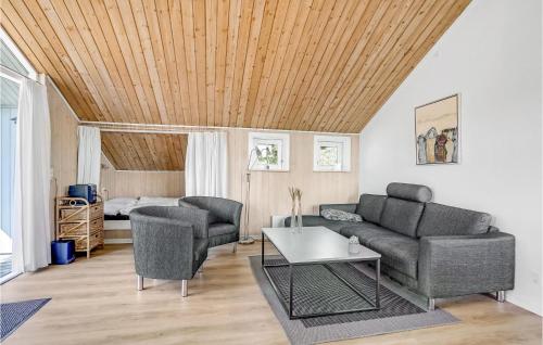 a living room with a couch and a table at Holiday Home Gl Hovej X in Blåvand