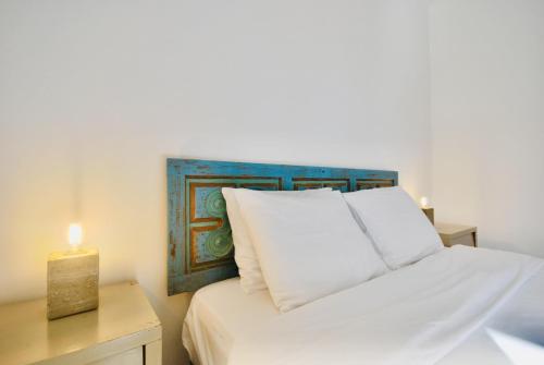 a bedroom with a bed with a candle on a table at Catarina House - Baleal Beach, Balcony, Pool in Ferrel