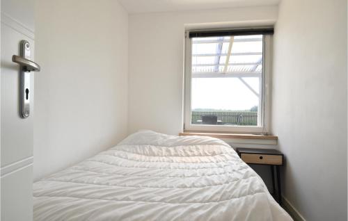 a bed in a room with a window at Awesome Home In Harboøre With Kitchen in Harboør