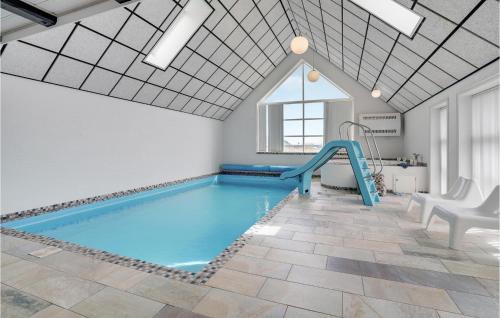 a swimming pool with a slide in a room at Beautiful Home In Harboøre With Sauna in Harboør