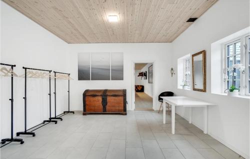 a room with white walls and a white floor and a table at Amazing Home In Grindsted With Sauna in Grindsted
