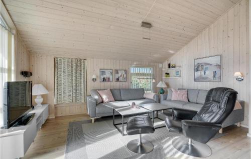 a living room with a couch and a table at Holiday Home Bellisvænget Hemmet Denm in Falen