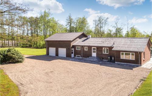 a house with a large driveway in front of it at Five-Bedroom Holiday Home In Kibak in Ørbæk
