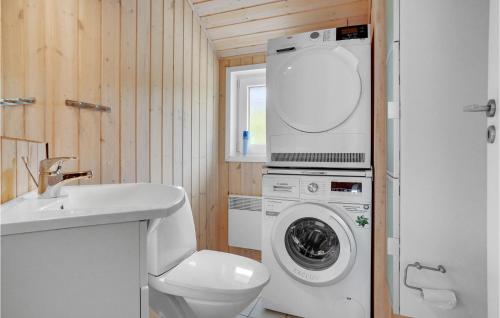 a bathroom with a toilet and a washing machine at Nice Home In Hovborg With Kitchen in Hovborg
