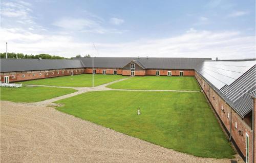 a large building with a large field of grass at Lønborggaard in Hemmet