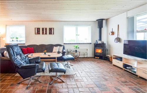 a living room with a couch and a table and a tv at Cozy Home In Vinderup With Wifi in Vinderup
