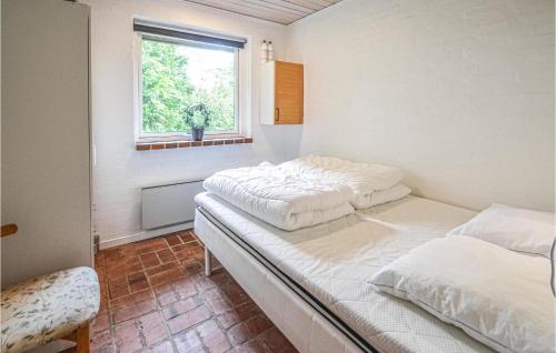two beds in a room with a window at Cozy Home In Vinderup With Wifi in Vinderup
