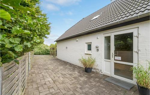 a white building with a door and a fence at Stunning Apartment In Thisted With Wifi in Thisted