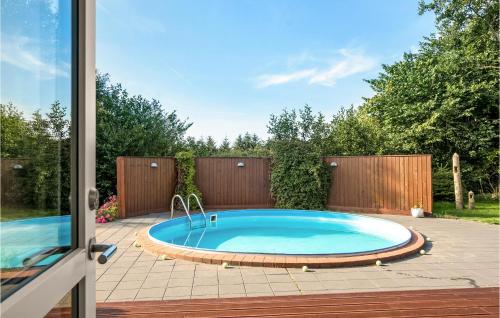 a swimming pool in a yard with a patio at Gorgeous Home In Vemb in Vemb
