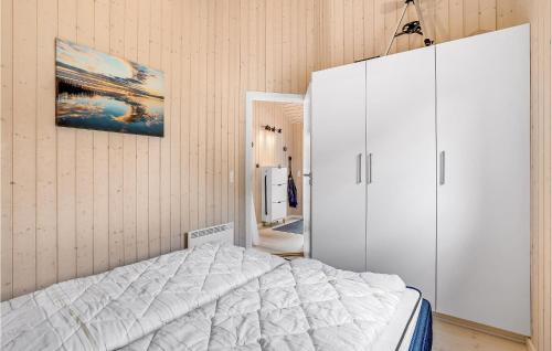 a bedroom with a white bed and a cabinet at Gorgeous Home In Vemb in Vemb