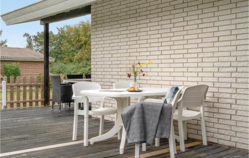 a white table and chairs on a deck at 3 Bedroom Amazing Home In Hurup Thy in Sindrup