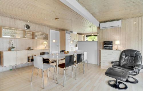 a kitchen and dining room with a table and chairs at 3 Bedroom Amazing Home In Hurup Thy in Sindrup