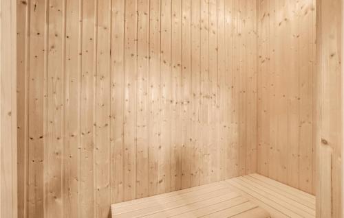 an empty sauna with wooden walls and a wooden floor at Holiday Home Skovvej Thyholm Xii in Thyholm