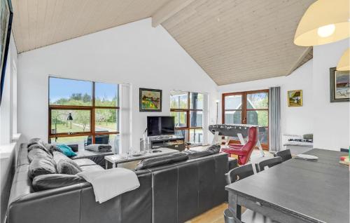 a living room with couches and a ping pong table at Holiday Home Skovvej Thyholm Xii in Thyholm