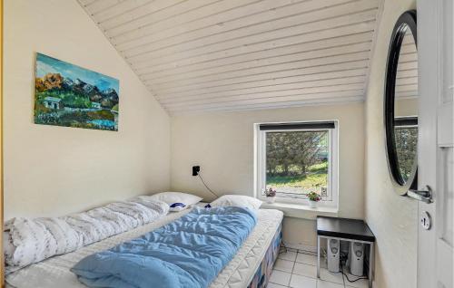 two beds in a room with a window at Beautiful Home In Struer With House Sea View in Struer