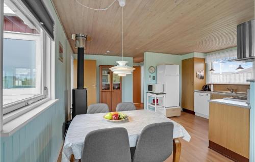 a kitchen and dining room with a table and chairs at Holiday Home Vinderup 5 in Vinderup