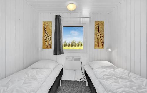 a room with two beds and a window with giraffe pictures at Stunning Home In Vemb With Wifi in Vemb