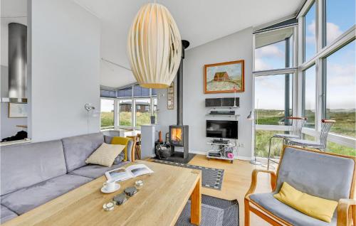 a living room with a couch and a table at Holiday Home Holdvej in Ringkøbing
