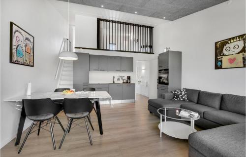 a kitchen and a living room with a table and chairs at Gorgeous Apartment In Ringkøbing in Ringkøbing
