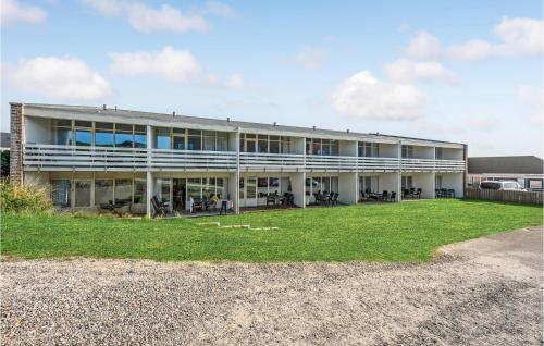 a large building with a yard in front of it at Gorgeous Apartment In Ringkøbing in Ringkøbing
