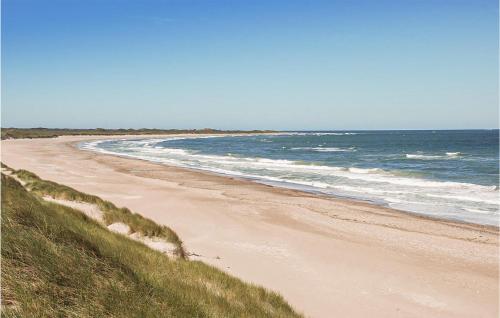 a sandy beach with the ocean in the background at Cozy Home In Hanstholm With Kitchen in Hanstholm