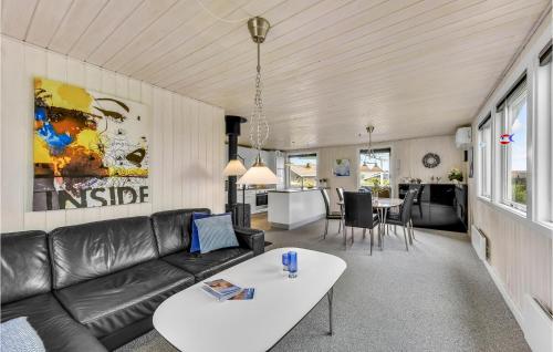 a living room with a couch and a table at Holiday Home Fyrmarken Hvide Sande in Nørre Lyngvig
