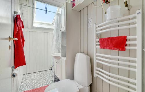 a bathroom with a toilet and a red towel at Amazing Home In Lgstr With Kitchen in Trend