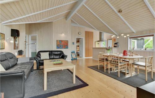 a living room with a couch and a table at Holiday Home Lindevej Broager Ix in Broager