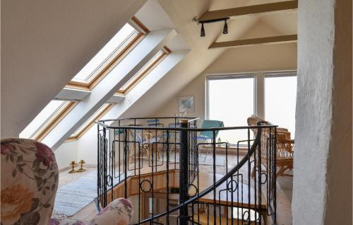 a living room with skylight ceilings and a spiral staircase at Two-Bedroom Holiday Home In Lemvig in Nørby