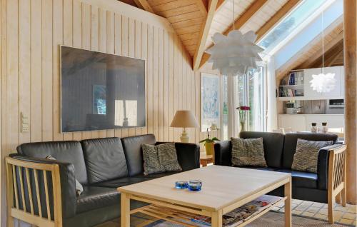 a living room with a couch and a table at Holiday Home Tulipanvej Fjerritslev I in Slettestrand