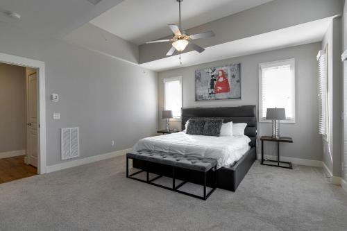 a bedroom with a bed and a ceiling fan at Music Row Luxury Suites - Two King Bedrooms - Private Garage & Ensuite Baths in Nashville