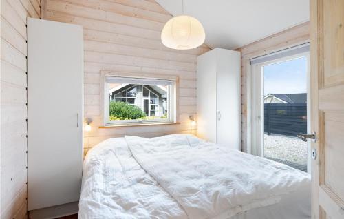 a bedroom with a bed and a window at Lovely Home In Sjlund With Kitchen in Hejls