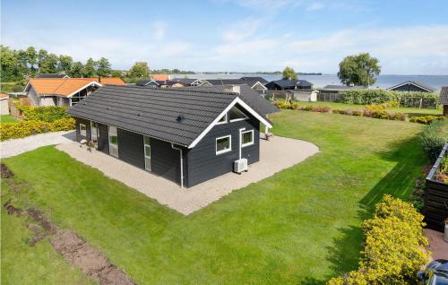 a black house with a large yard at Holiday Home Anemonevej Sjølund I in Hejls