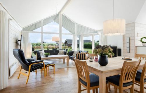 a living room with a table and chairs at Holiday Home Anemonevej Sjølund I in Hejls