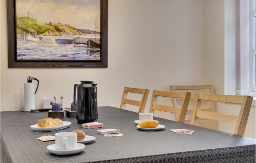a table with plates of food and a coffee maker at Nice Home In Thyborøn With Wifi in Thyborøn