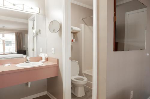 a bathroom with a sink and a toilet at Admiral Motel in Lake George