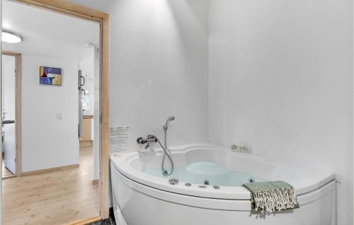 a white tub in a bathroom with a shower at Amazing Home In Hvide Sande With Wifi in Hvide Sande