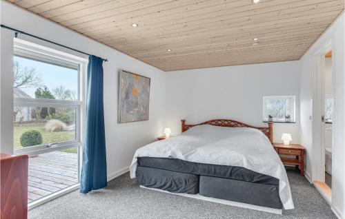 1 dormitorio con cama y ventana grande en Awesome Home In Haderslev With 3 Bedrooms And Wifi, en Kelstrup Strand