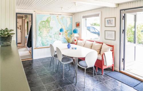 a room with a table and chairs and a couch at Lærkereden in Årøsund