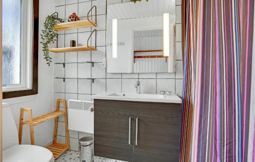 a bathroom with a sink and a mirror at Nice Home In Haderslev With Kitchen in Kelstrup Strand