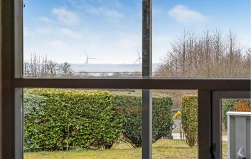 an open window with a view of wind turbines at Gorgeous Home In Ebeltoft With Sauna in Ebeltoft