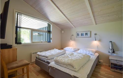 a bedroom with two beds and a window at Nice Home In Give With 3 Bedrooms, Sauna And Wifi in Lindet