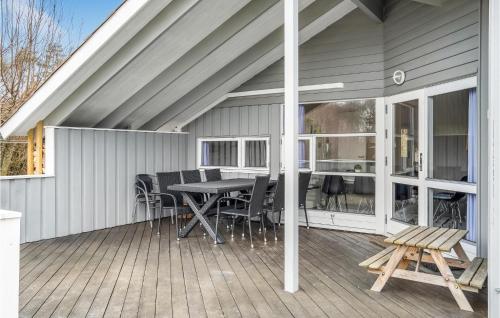 a screened in porch with a table and chairs at Gorgeous Home In Ebeltoft With Sauna in Ebeltoft