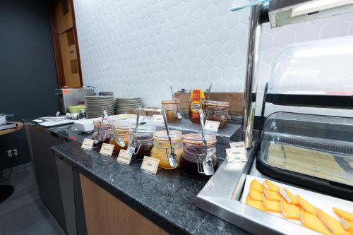 a counter in a kitchen with jars of food at Holiday Inn Calais-Centre by IHG in Calais