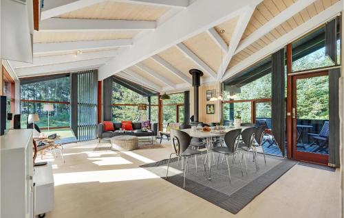 a kitchen and dining room with a table and chairs at Holiday Home Rønnevej Fjerritslev Ix in Fjerritslev