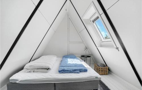 a bed in a white room with a window at Two-Bedroom Holiday Home In Ulfborg in Fjand Gårde